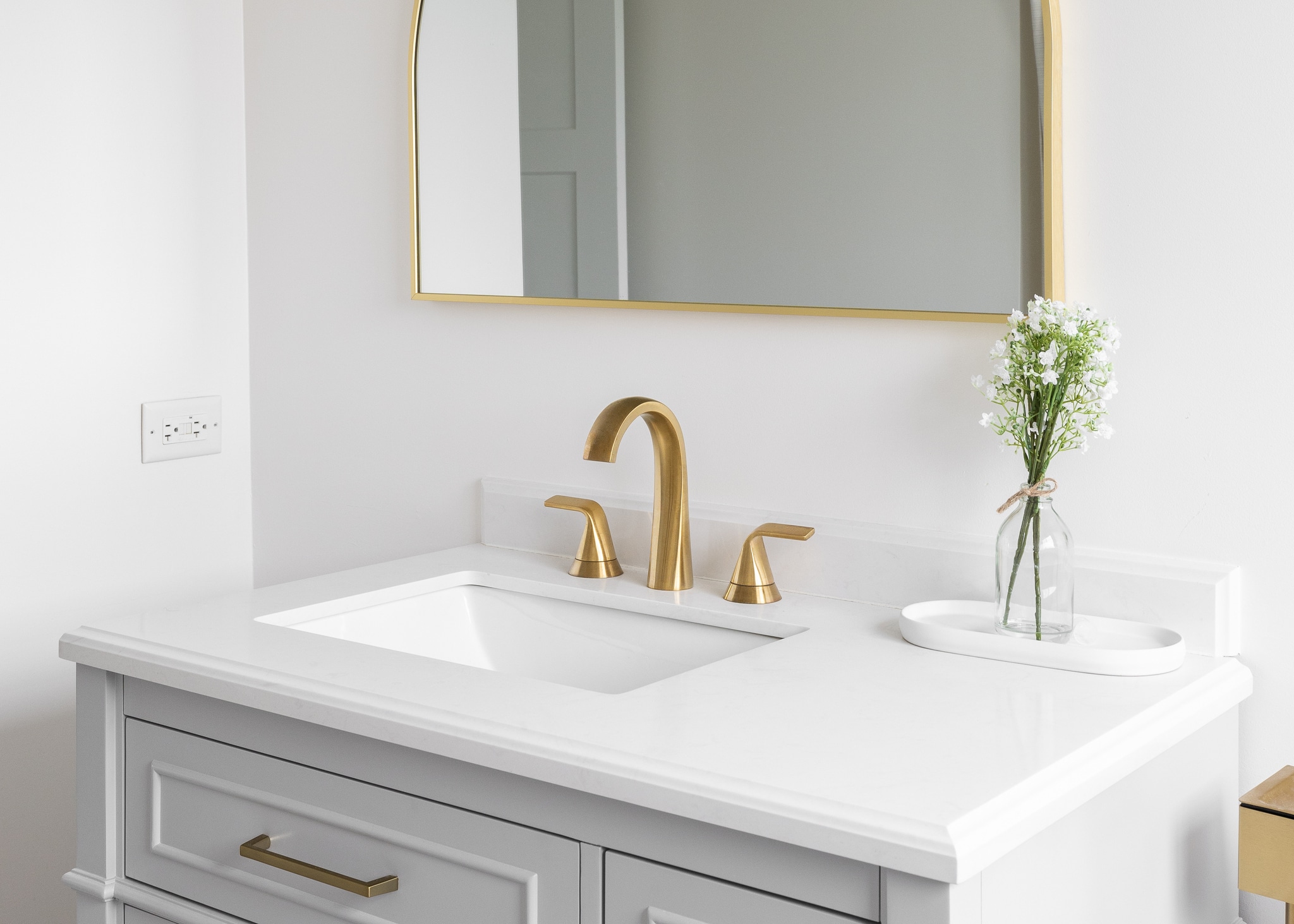 A golden faucet on a white marble countertop, Choose the Right Faucet.